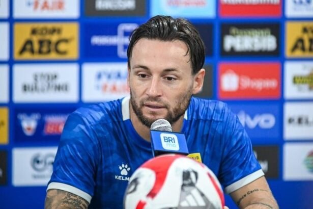 Marc Klok mengenakan jersey Persib Bandung saat konferensi pers.